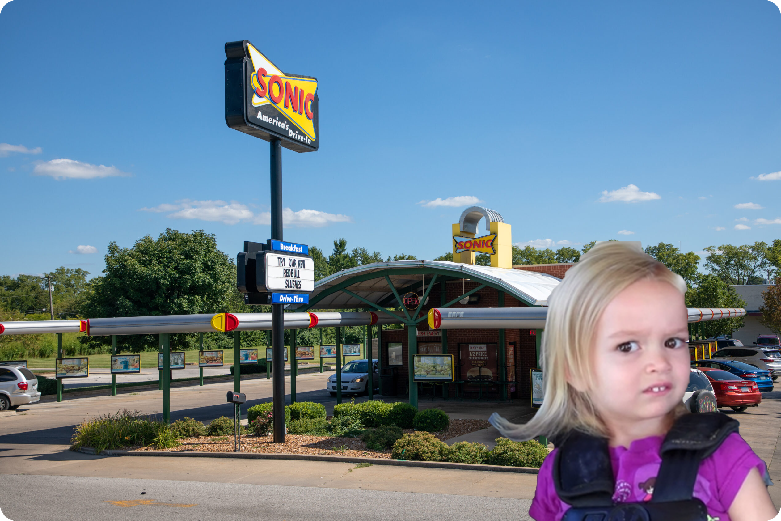  a litle girl frowning at sonic drive thru